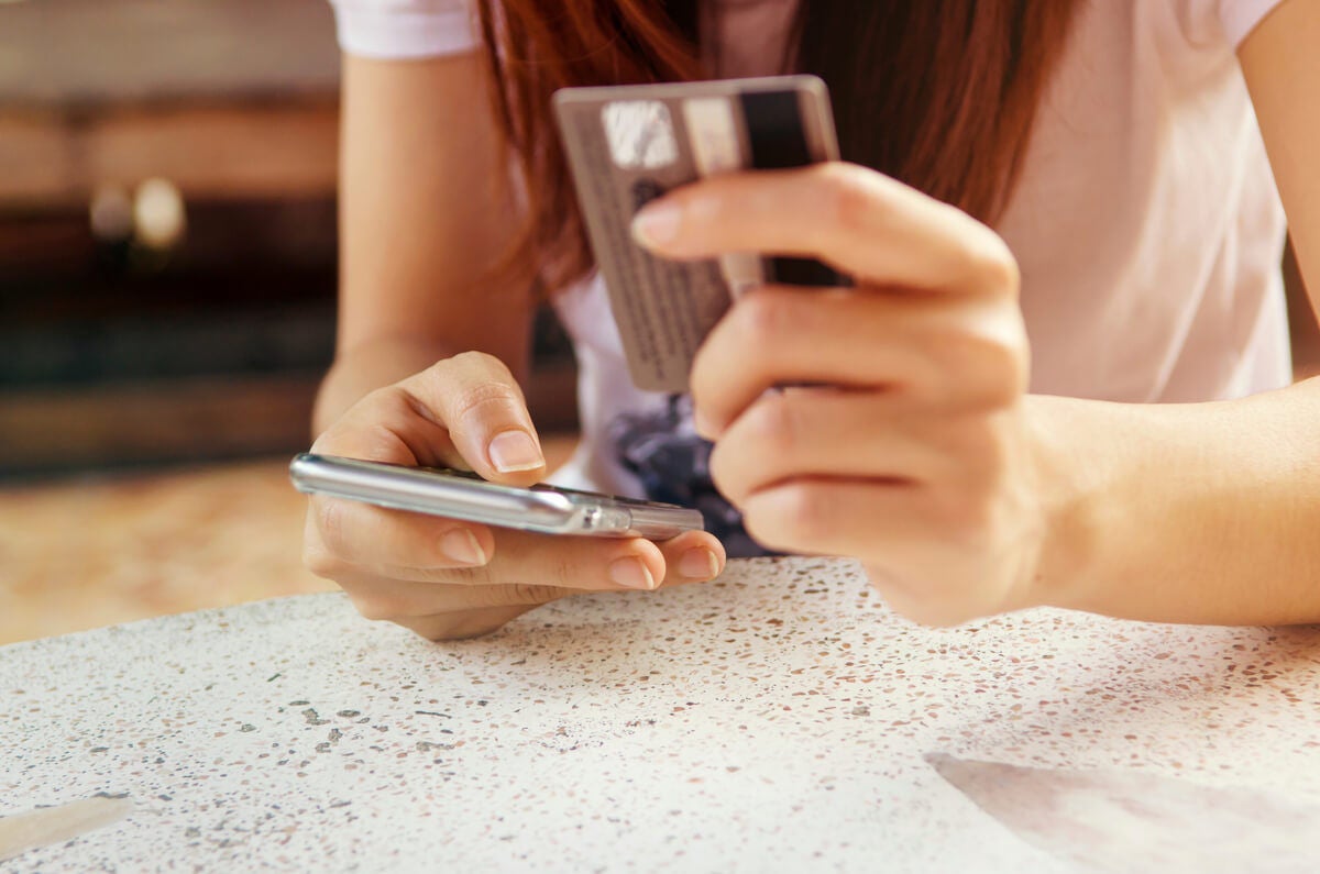 Woman researching how to pay off her credit card debt.