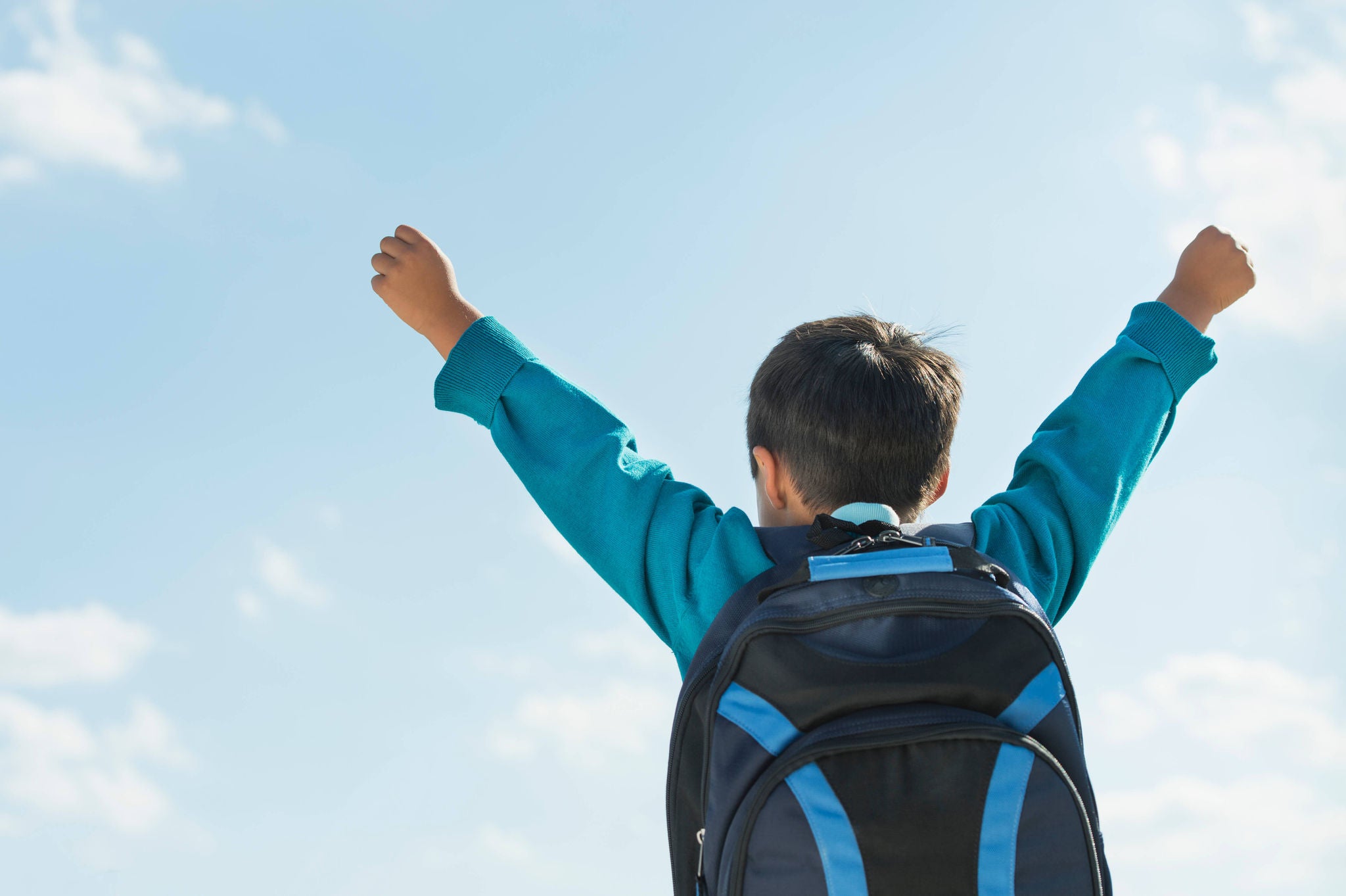 A kid who is excited about his savings on Back to School shopping